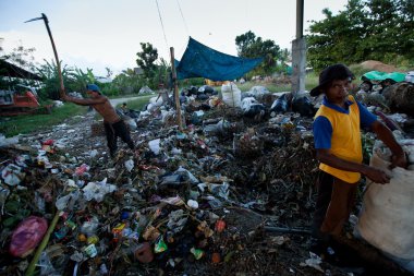 BALI, INDONESIA  APRIL 11: Poor from Java island working in a scavenging at the dump on April 11, 2012 on Bali, Indonesia. Bali daily produced 10,000 cubic meters of waste.